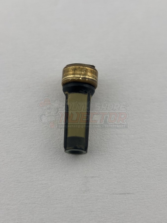 Clogged fuel injector inlet filter packed with brown debris and varnish, pulled during a cleaning